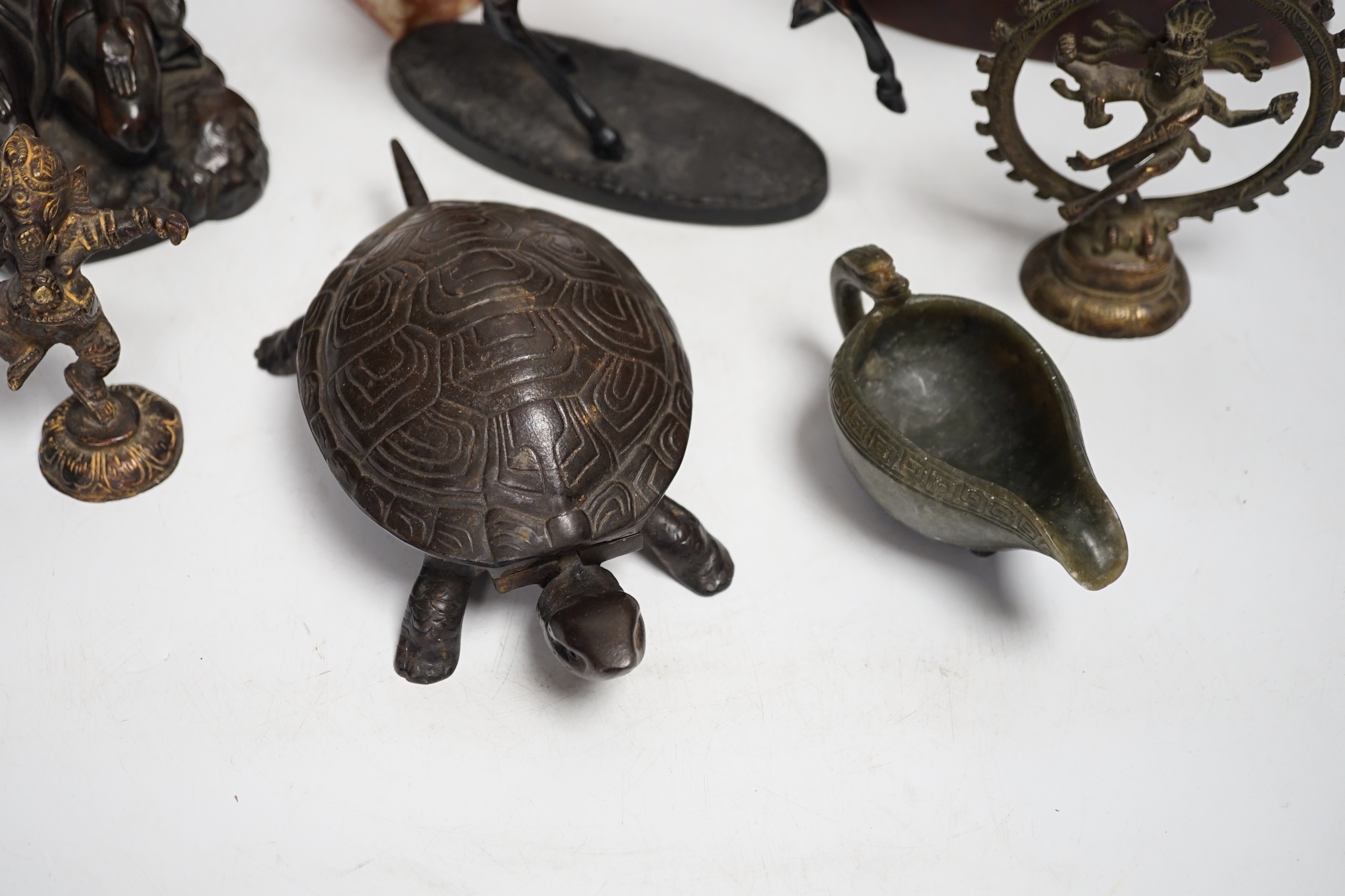 Mixed metal and carved ornaments, including a tortoise table bell, a statue of two dancers and a Balanese head, etc, 22cm